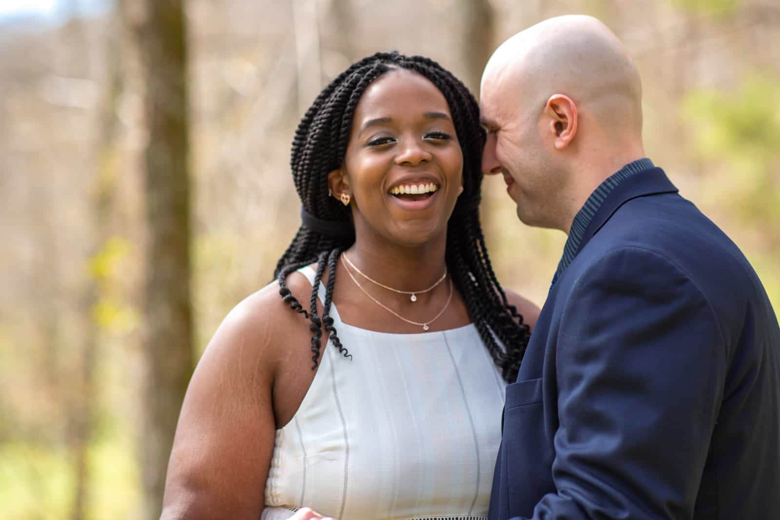 Spring Nashville Elopement at Butterfly Hollow; bride and groom portrait with bride laughing as he whispers to her